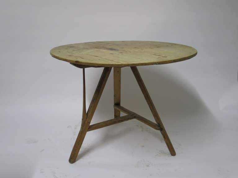 Antique round folding dining/center table from Holland.

Fruitwood top on pine tripod base with handcarved wood handle. 

Nice patina, good sturdy condition. 

19th C. Holland.