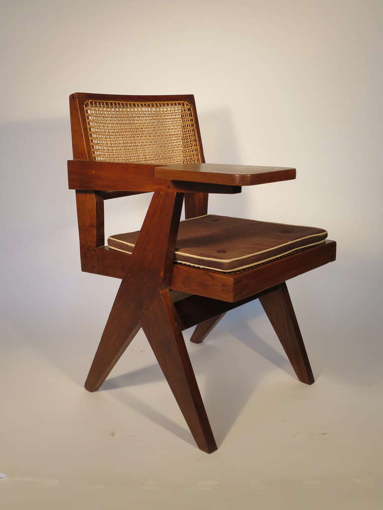Exquisite example of the Writing Chair by Pierre Jeanneret c. 1960. 

Model number PJ-SI-26-E; version without a tablet under the seat. 

Beautiful solid teak with repaired caning and new cushion to match original.