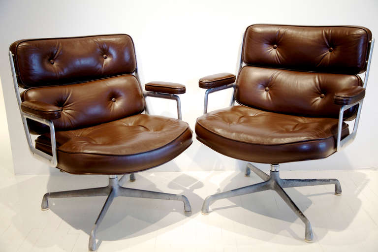 Pair of original Eames Time-LIfe Chairs, also known as the Eames Executive Chairs. 

Deep brown leather, adjustable height, adjustable tilt, and swivel.  

Orginally the chairs were created for the three ultramodern lobbies of the Time-Life