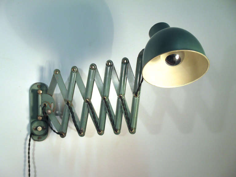 Vintage accordion wall lamp in patinated green enamel. 
 
15