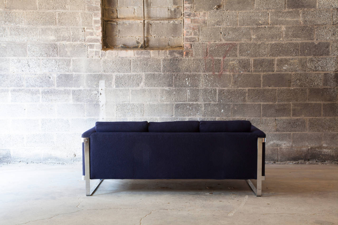A newly reupholstered navy wool and chrome sofa by Milo Baughman with distinctive clean lines.