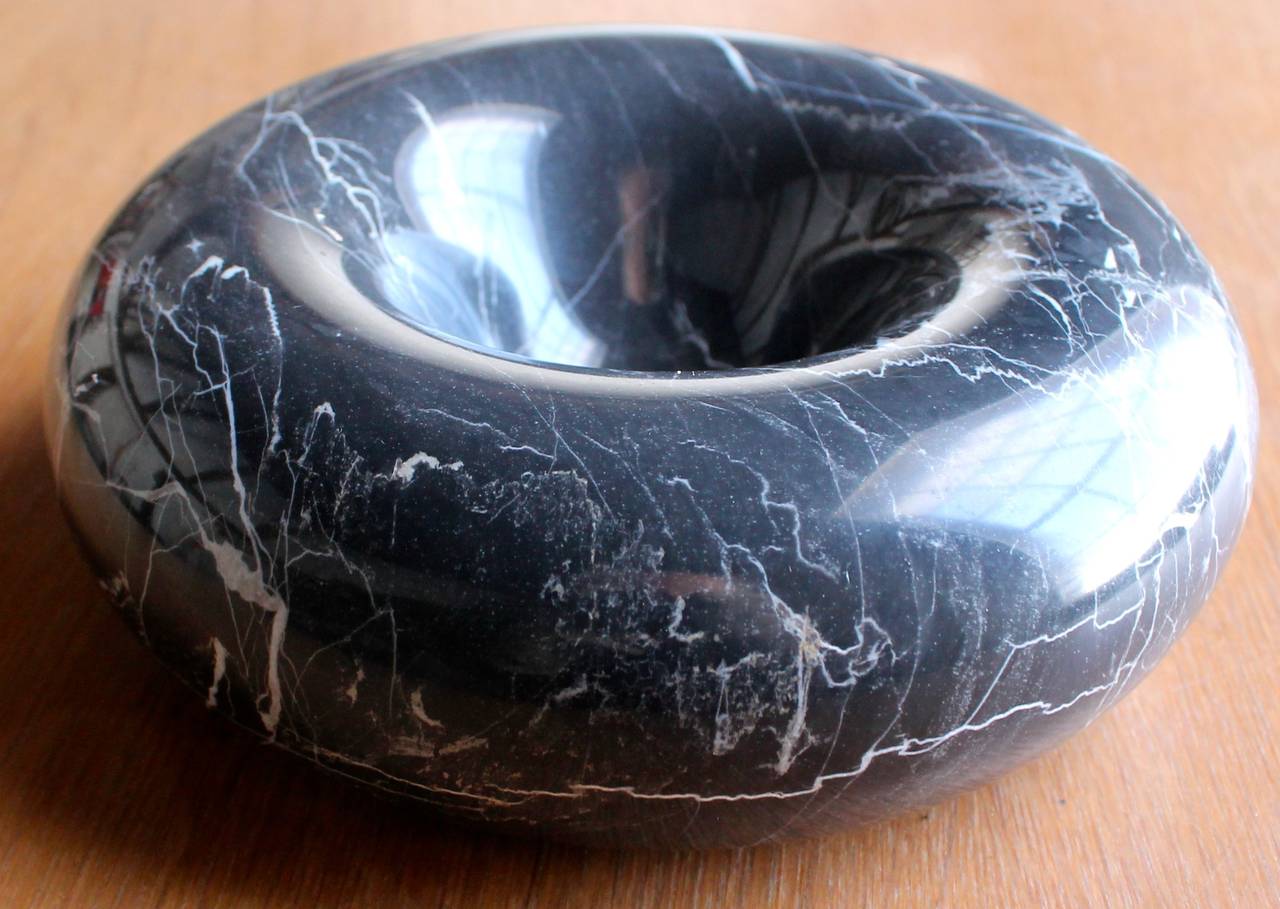 A small black marble bowl by Sergio Asti.