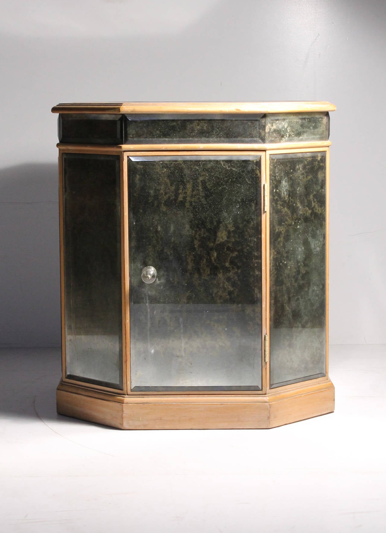 Vintage mirrored octagon occasional table cabinet attributed to Grosfeld House. Lucite sphere pull. A Deco style. May complement well in a Dorothy Draper Interior.