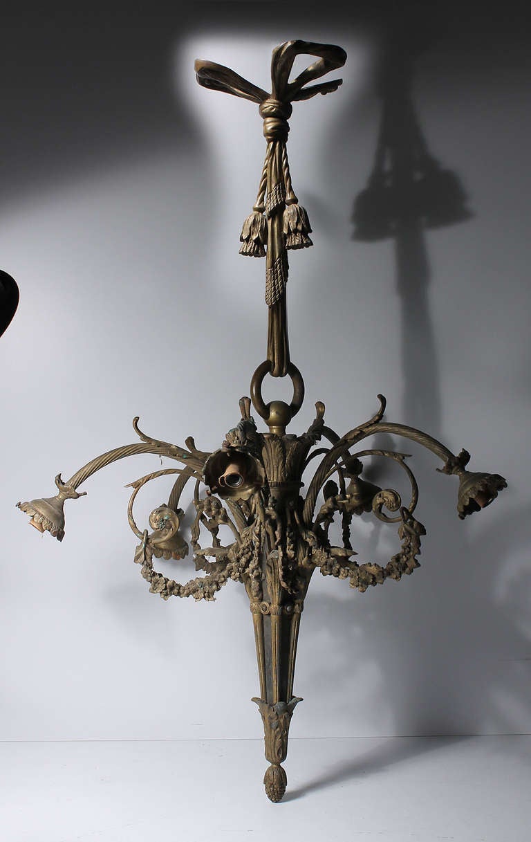 A five-arm French (Gilt Gold) bronze chandelier. Castings are highly detailed and ornate. Dating to the end of 19th century to first quarter of the 20th century. Highly patinated. A period fixture. (Empire Style)

Need to confirm the dims on this.