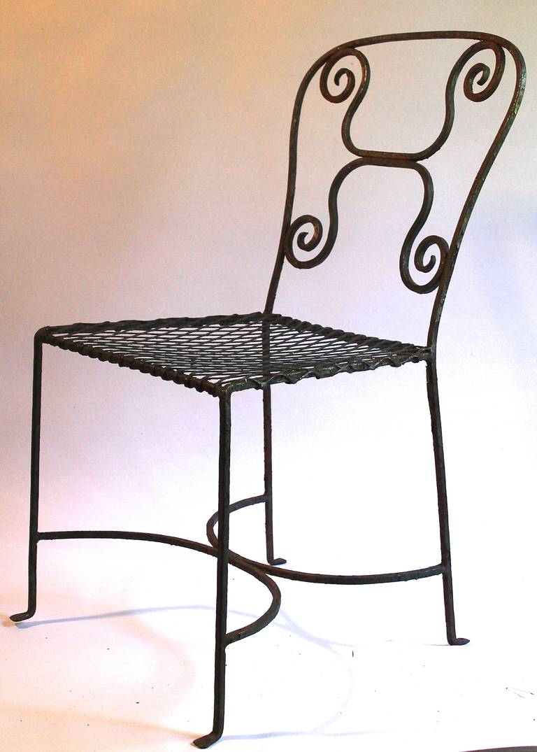A pair of hand made wrought iron side chairs.  Material is very thin and well constructed.