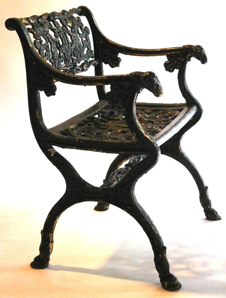 Design inspired by Schinkel.  Cast iron armchairs with hoof feet,  angel's sculpted on the backs,  ram heads on arms with lyre sculpted seats.  Geo. Himmelheber 