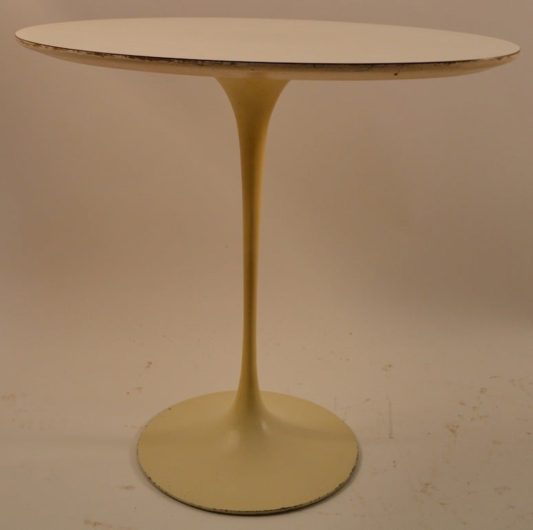 Vintage original Saarinen for Knoll oval tulip table. Cast iron base with white laminate top. This example shows some cosmetic wear normal and consistent with age.