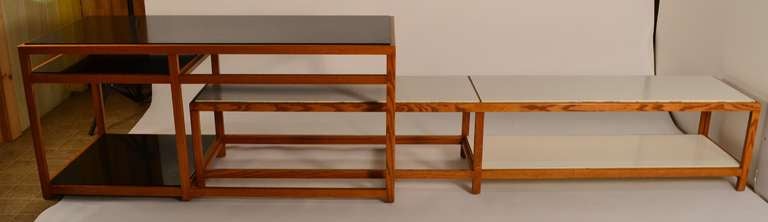Two tables of Ash and laminate, designed by Edward Wormley for Dunbar. These tables can  be nested as one long console, at a right angle to fit a corner, or use separately as two distinct tables. Elegant and sophisticated Mid Century design,