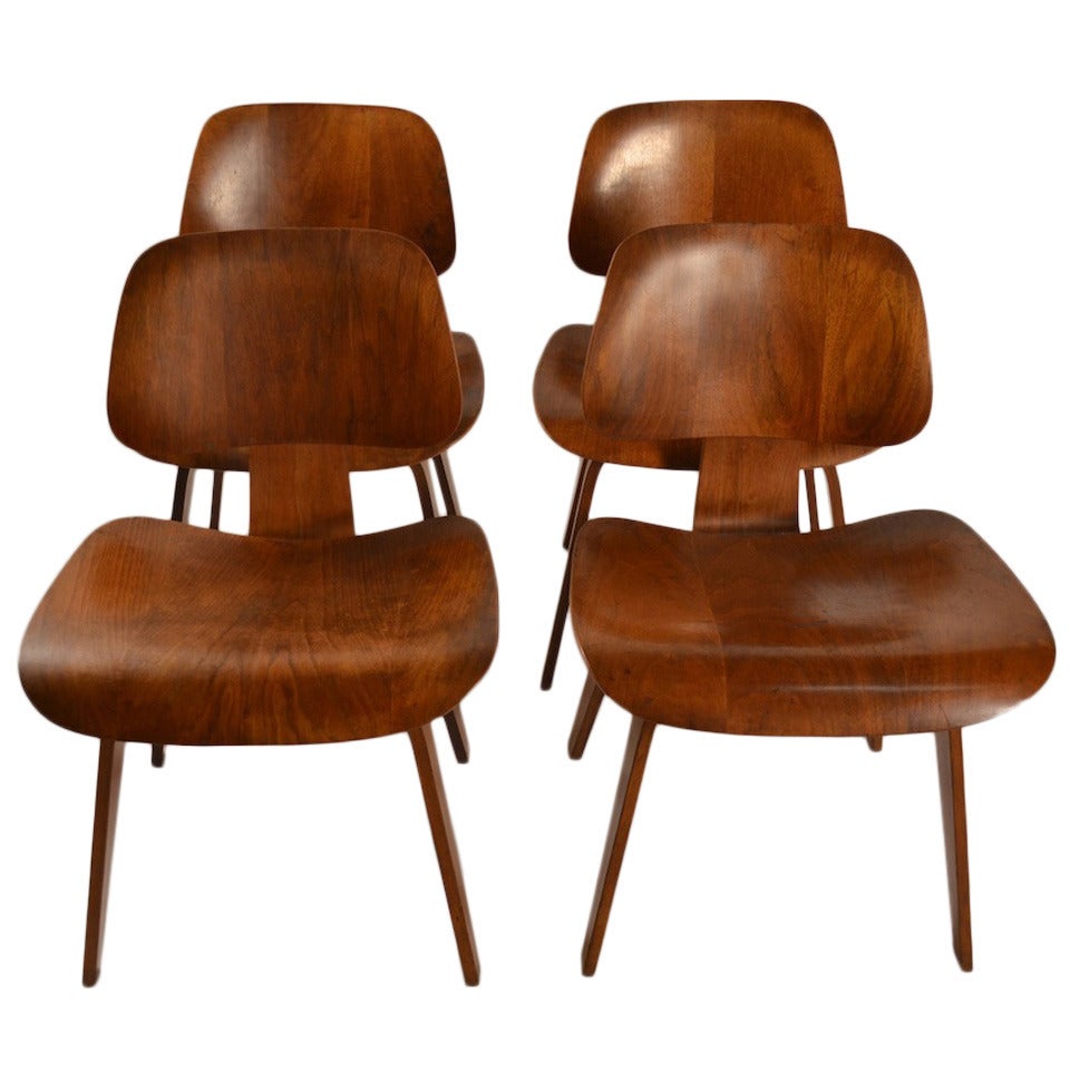 Set of Four Eames DCW Dining Chairs in Walnut at 1stDibs