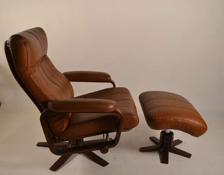 Brown leather seat, and ottoman, canvass back, wood and steel frame. Supple soft pad, and adjustments make this an extremely comfortable lounge, reading, napping chair.