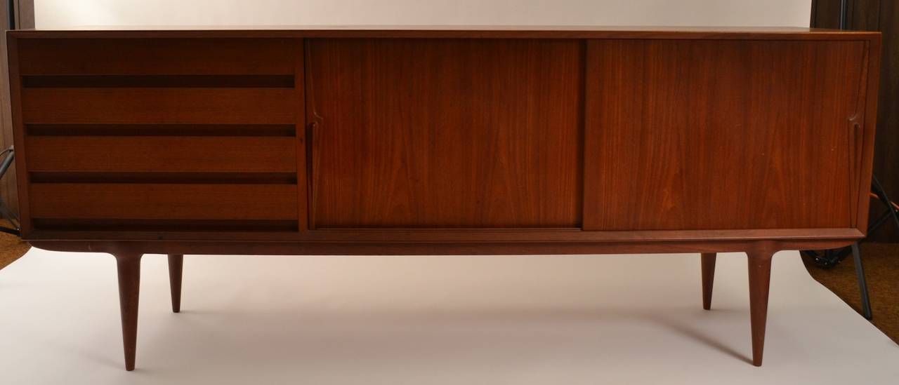Nice credenza designed by Gunni Omann,  four drawers on one side, two sliding doors on the other, which open to storage. Great form provides ample storage, ready to use original condition.