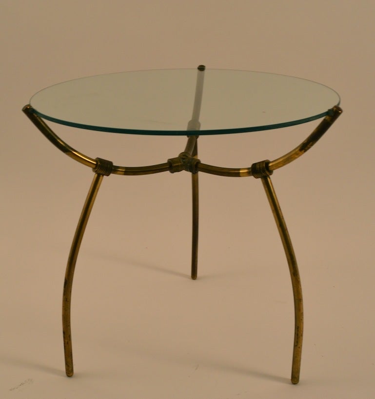 Interesting tubular brass base glass top occasional, or end table in the Italian style, possibly Italian, or American made. Design influenced by Parisi, and Ponti.