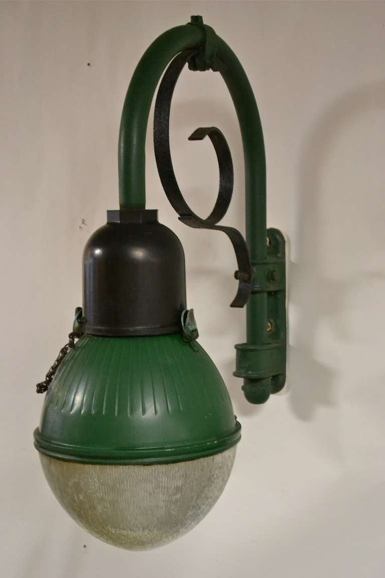 Pair of period Industrial wall mount sconces, cast iron wall mount plate, bent steel arm, with 