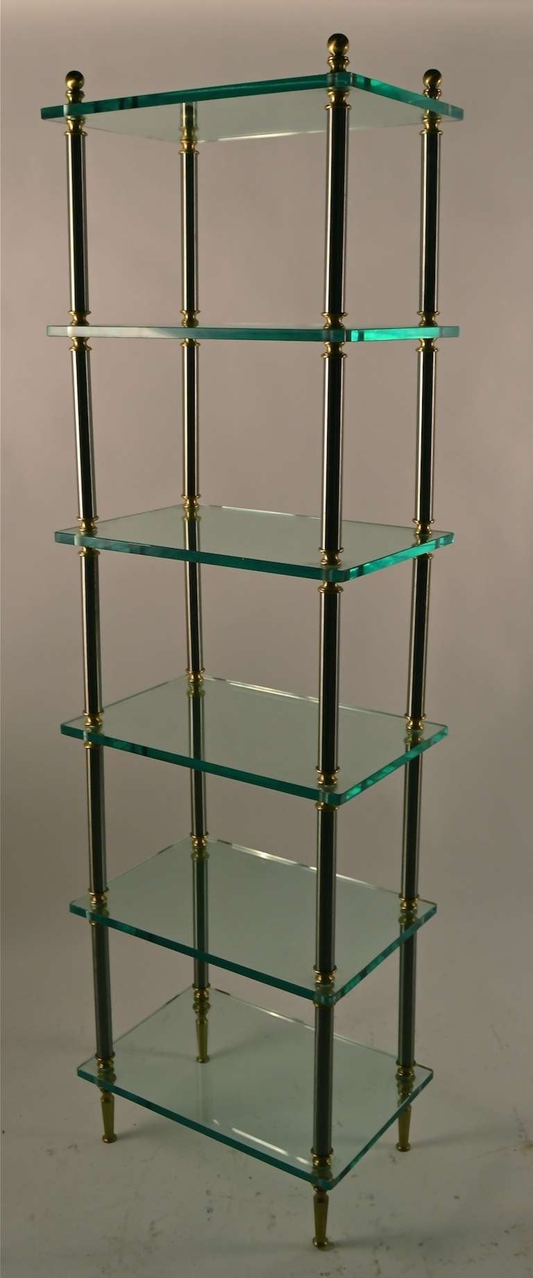 Elegant six shelf plate glass etagere with tubular vertical and brass supports. Each thick ( 5/8