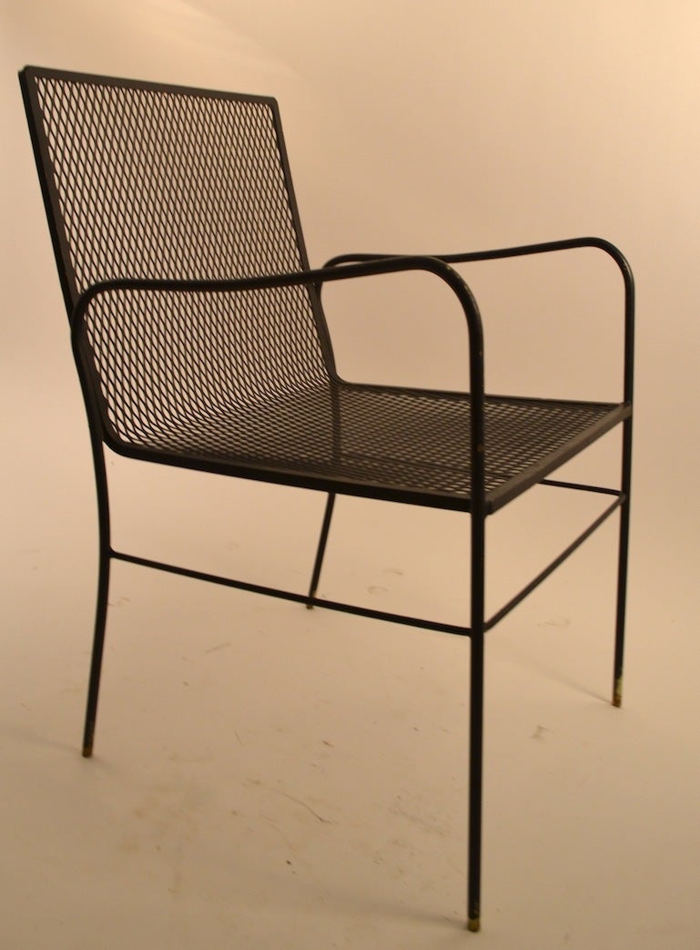 Unusual form, elegant, subtle and sophisticated design, and comfortable too. Six matching arm chairs, dining height, in black paint finish. No breaks, welds, or repairs.