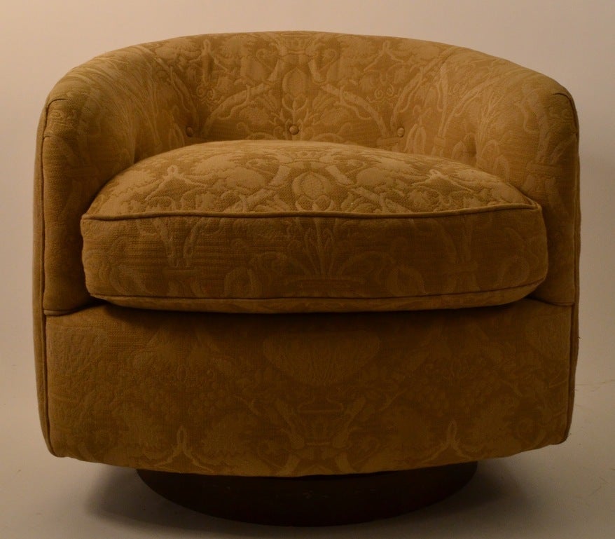 Great quality Art Deco swivel and tilt overstuffed tub chairs, in very good original condition. The upholstered top rest on a circular walnut base, matched pair of comfortable, well made, period chairs.