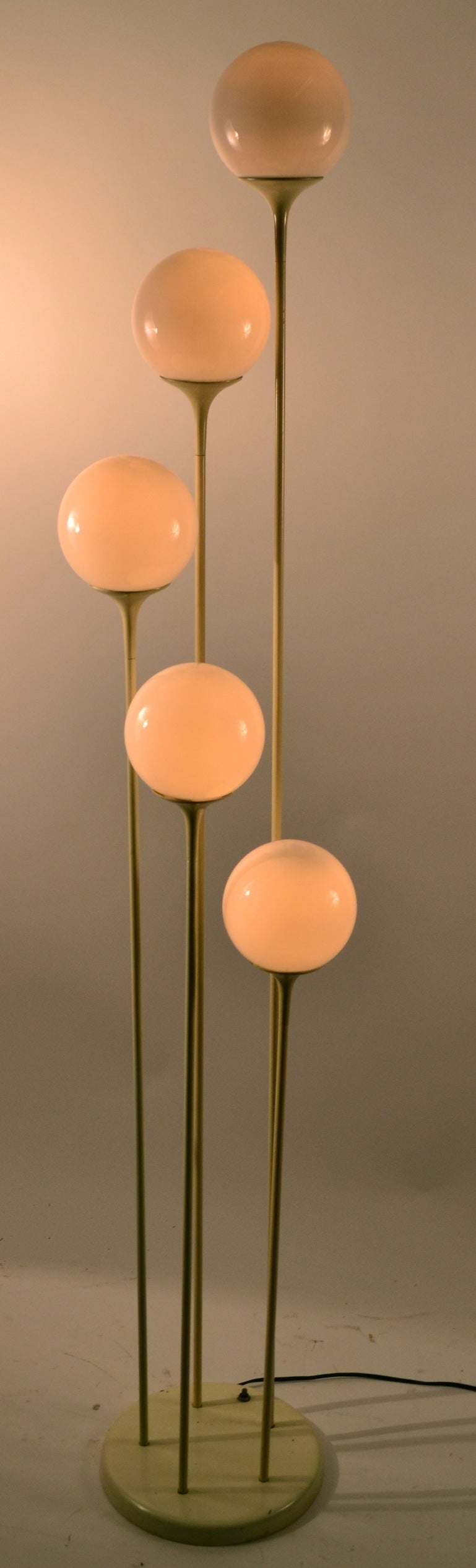 Five glass ball globes each mounted on free standing trumpet form posts. Saarinen influence design, probably by Lightolier.