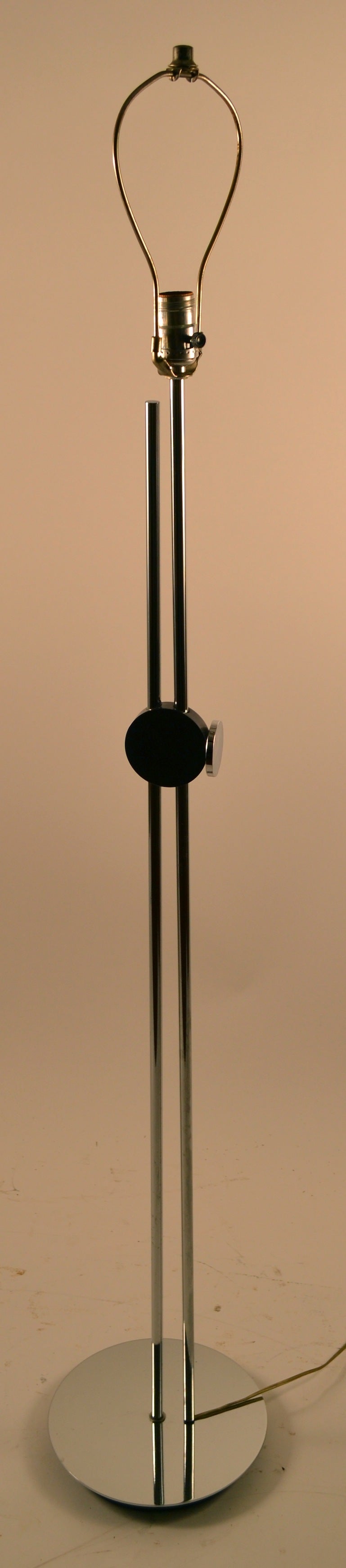 Sleek bright chrome adjustable floor lamp. One rod slides up and down to adjust the height of the shade ( 56