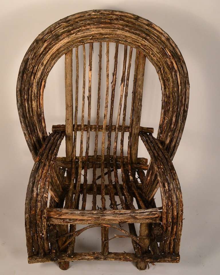 Large Adirondack lounge chair. Constructed of bent twigs, and sticks.