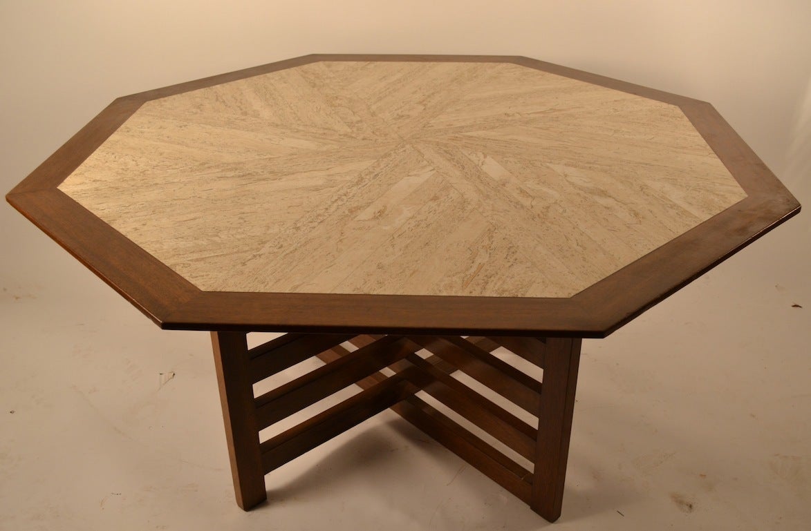 Octagonal marble top dining table, inset travertine marble surface rests on 