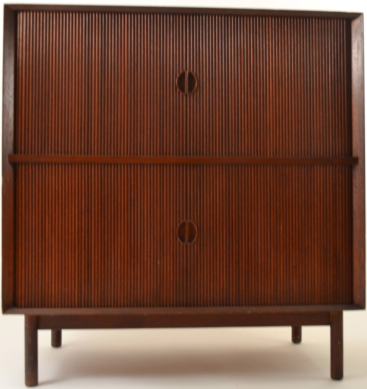 Two level cabinet each having a tambour slide which opens to shelved ( adjustable ) storage. Designed by Hvidt and Mlgaard Nielsen for Illums Bolighus.
This example is in original condition, it does show some signs of use and wear, normal and