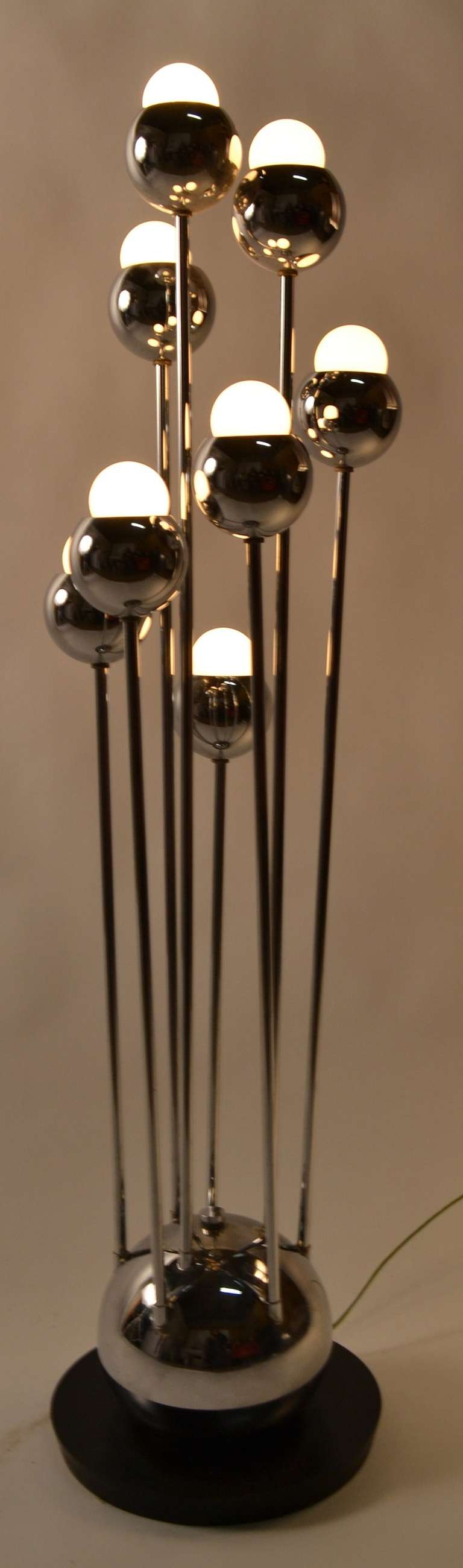 Post Modern Art Deco Revival decorative table lamp. The three way switch enables three distinct light combinations. Bright chrome arms, and ball base, mounted on disk form black base. Working, clean and original.