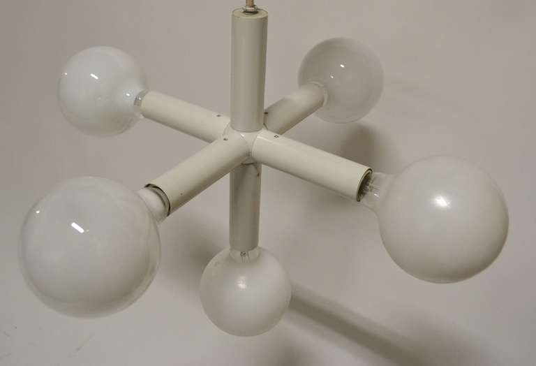 Space age tubular steel construction, in original white finish. Five sockets, which accept standard bulbs allowing for a variety of choices including the white ball bulbs shown, or clear, or silver tipped. Working, clean and stylish.