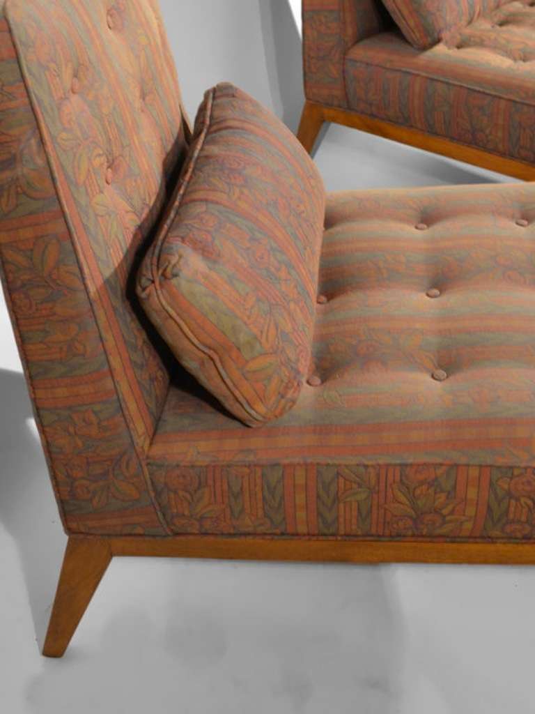 Pair of armless lounge chairs with ottomans in the style of Wormley for Dunbar. Measures: Chairs 32 1/2