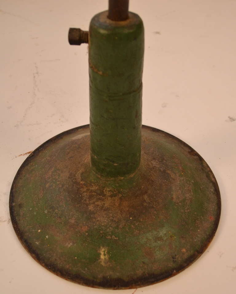 American Industrial stool, cast iron base, solid wool top.The top has the remains of an old flower decal, as shown. Most likely originally from a factory or work shop floor.