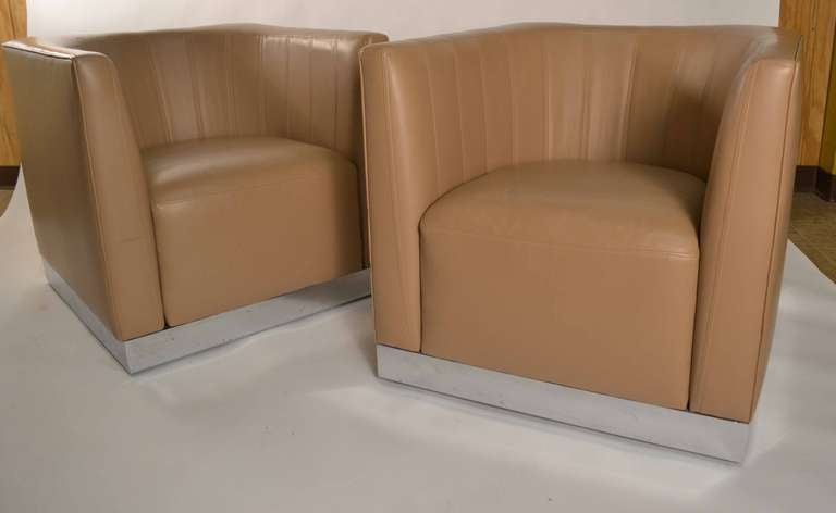 Soft tan leather upholstered chair rests on chrome base. High quality construction, fine condition with only very slight wear to the ( original ) leather seating.