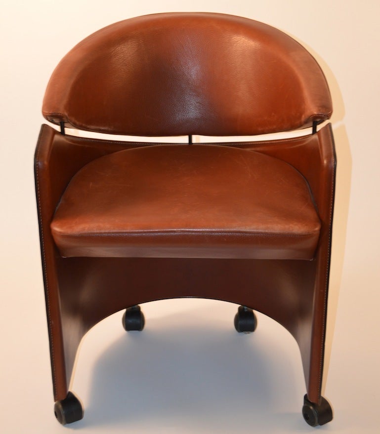 Very comfortable, well made, and well designed set of eight matching dining chairs. Tub chair form, on rolling coaster feet. Attributed to Bellini for Cassina.