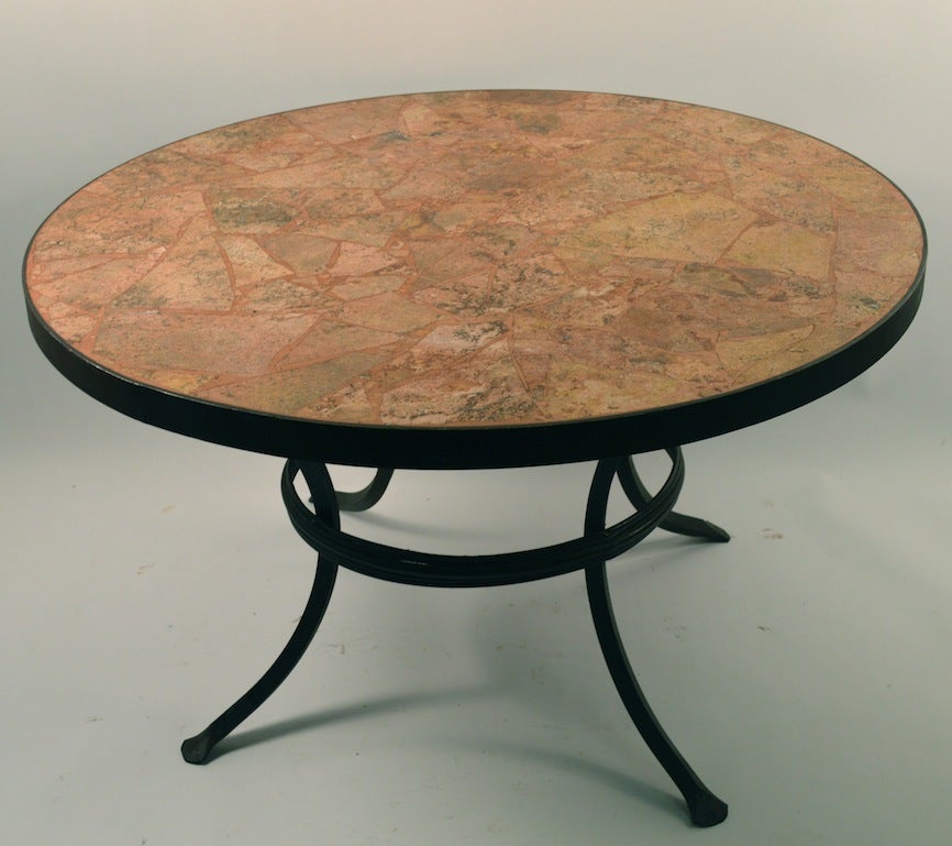 Iron base supports round terrazzo top, classical revival coffee, cocktail, occasional table. Suitable for indoor or outdoor use.