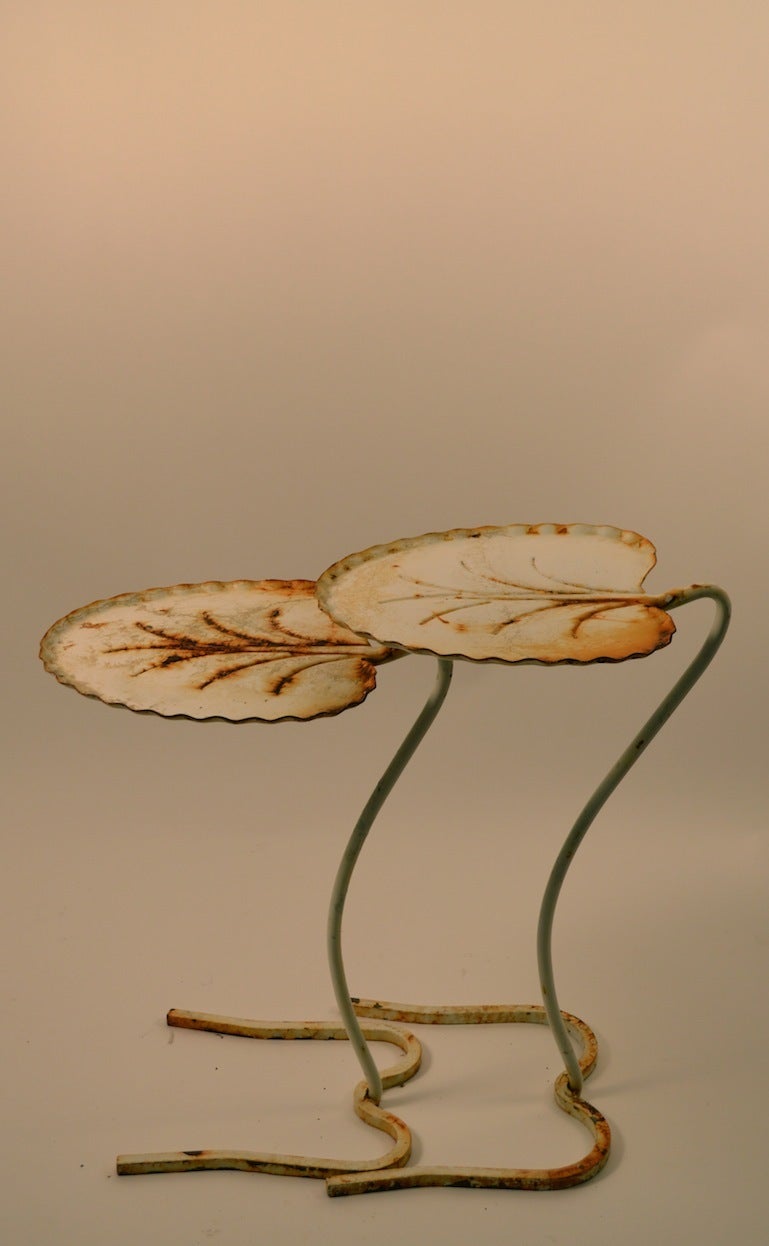 Two nesting Salterini leaf tables, in original white paint finish ( Worn as shown ).
Great set for your garden or patio.
Dimensions in listing are for the larger table, smaller table as follows:19