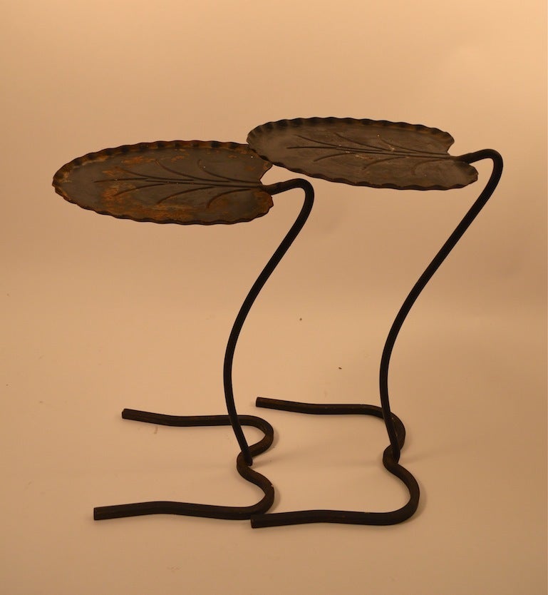 Salterini nesting tables in original black paint finish. Surface shows wear consistent with outdoor use. Dimensions in listing are for larger table, smaller table as follows: 
19