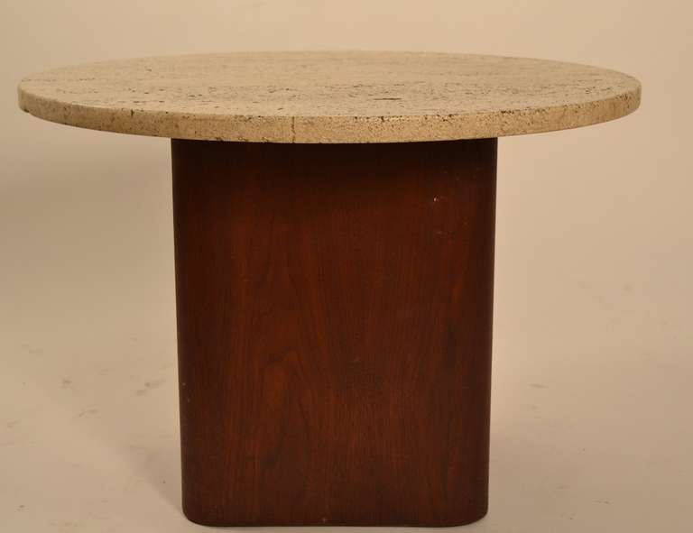 Simple clean form, round disk travertine top rest on walnut veneer pedestal  base.