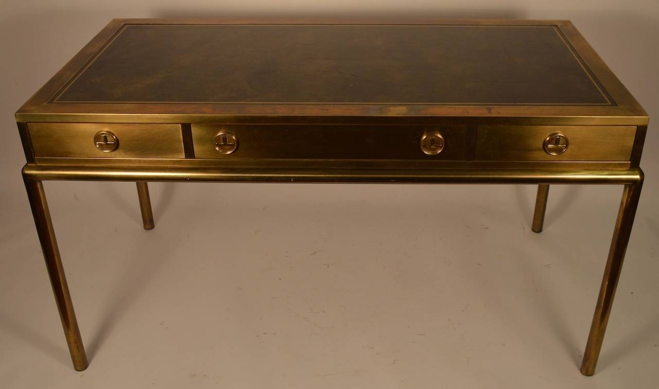 Brass trim desk, with leather top, original chair included. Bernard Rohne design for Mastercraft. This elegant flat top (leather top) platform desk has three drawers, it is in original finish, and excellent overall condition. The leather top has one