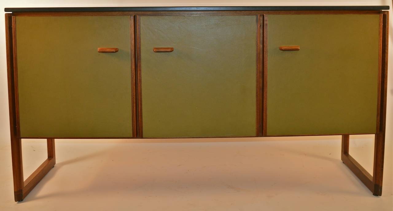 Rare leather front Risom cabinet, with stone top. Three door server, two doors open to revel shelved storage, one door opens to a bank of interior drawers. Very fine original condition, hard to find example, Mid Century Modern design. Credenza,