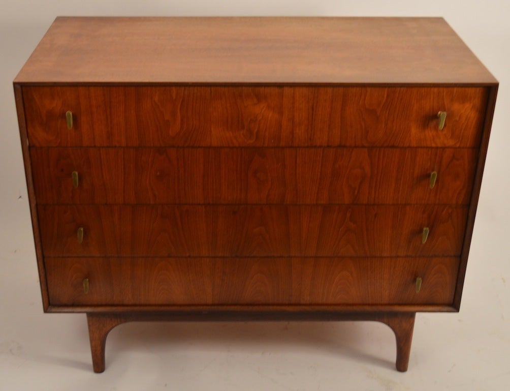 Four drawer bachelors chest, with figured veneer drawer fronts and brass pulls, on raised  sculpted legs. Please view the matching pieces we've listed from the suite, if you need more pieces.