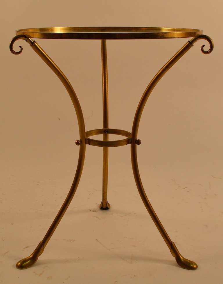 Elegant stands in brass with circular glass disk tops.