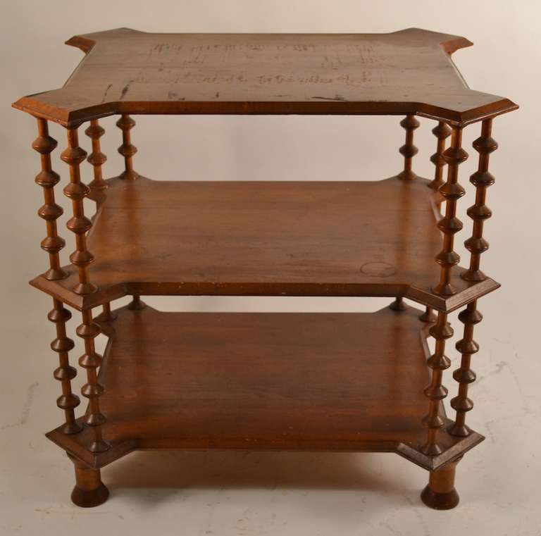 Hard to find form, three tier  center table, with beveled pine shelves, and spool vertical elements. Normal wear to ( original ) finish. Solid and sturdy condition.