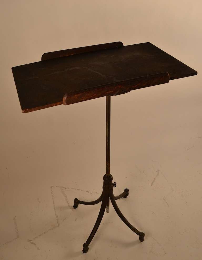 Antique Industrial stand - cast iron, with oak top. The top will tip and the vertical post will raise and lower, to adjust height. 
Great as pedestal, Maitre d stand or drafting table.
 Top surface, 25.5 x 16