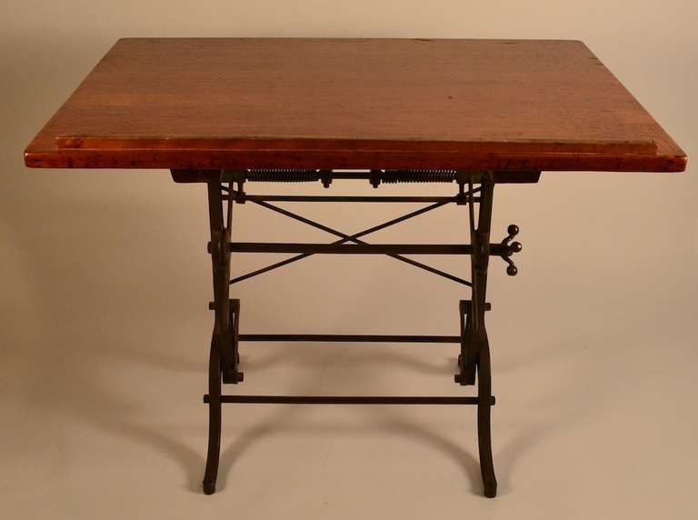 Antique adjustable drafting table, wood top, cast iron base.. The top will raise/lower ( 32.5