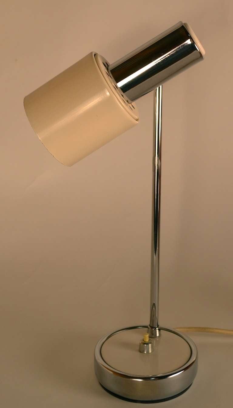 Adjustable Italian desk lamp. Swivel and tilt cylindrical hood shade allows for positioning and direction of light. Cream enamel and bright chrome  original finish, working and wired for US application.
Hood shade 6