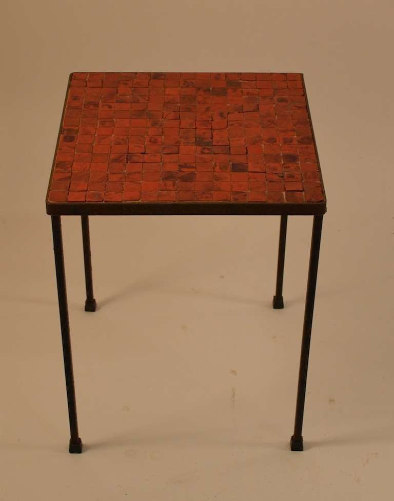 Square mosaic top tables, with squared iron legs. These tables were originally on a sun porch, and show the appropriate surface patina, specifically, light surface rust to the iron surfaces. Very chic minimalist proportions, selling  in original