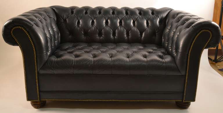 Love seat size leather Chesterfield sofa, in dark navy leather. Wear consistent with age, comfortable, and stylish, manageable size.