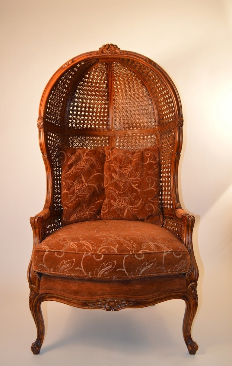 Hood enclosed top with caned back, carved wood frame, with cabriole legs. French style probably American manufacture.