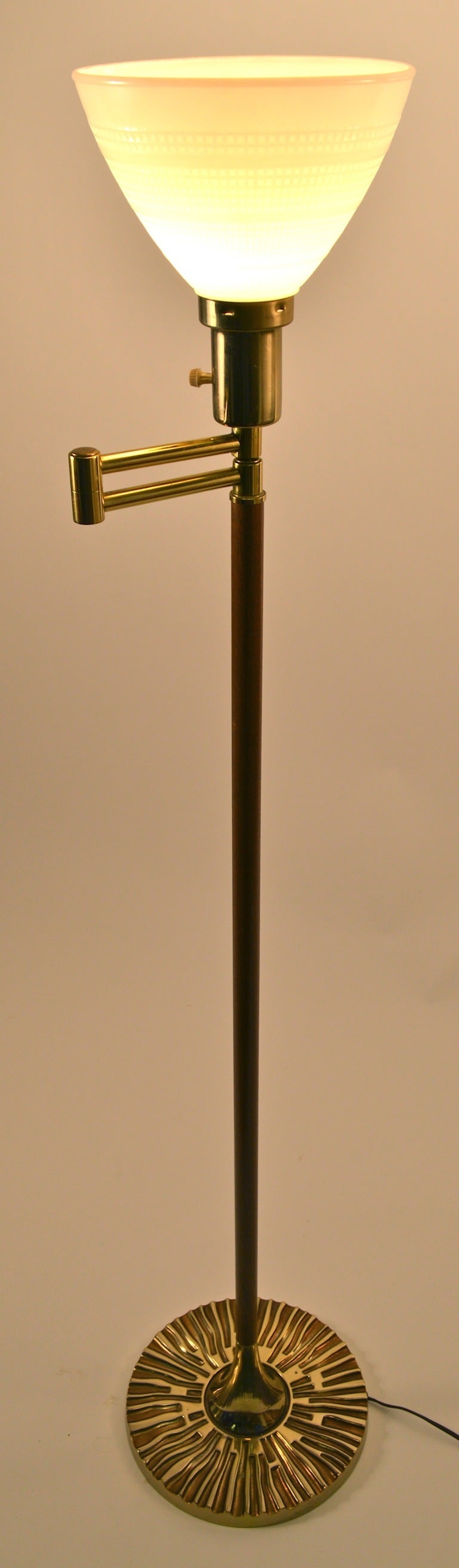 Cast Brutalist gold tone base, wood vertical standard, with brass jointed swing arm top. Can be used with or without shade, as shown.