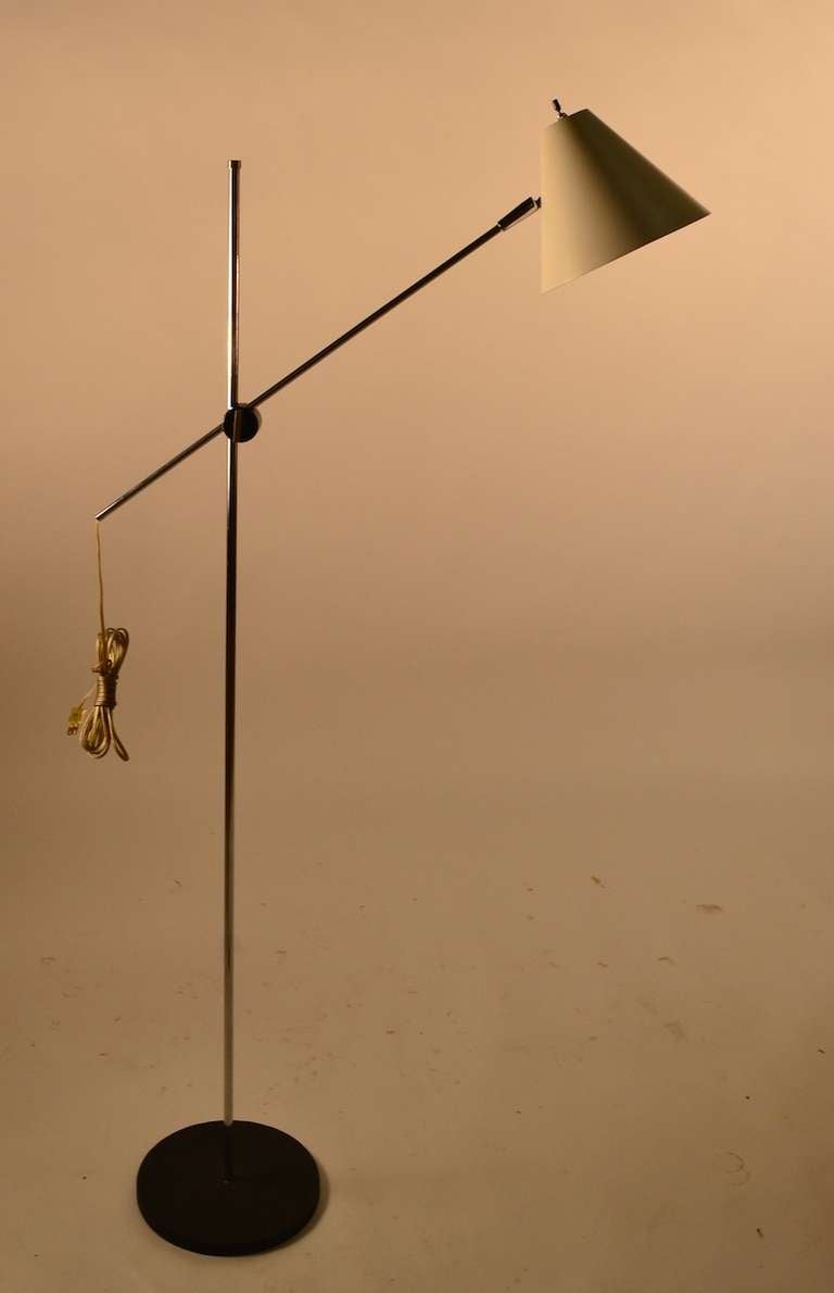Adjustable floor, reading, pole lamp. The cone shade tilts and pivots, it's arm will adjust in length , and also angle. These adjustments enable almost infinite positioning of the light.