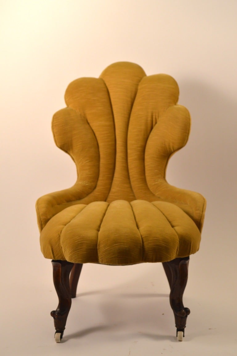 Stylish Victorian upholstered lounge, side chair. Upholstered back and seat on rosewood legs, with original porcelain coaster wheel feet. Great for a boudoir, fireside, or decorative occasional chair.