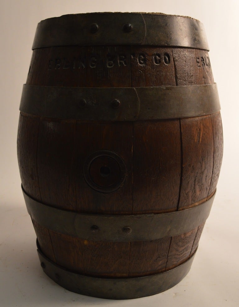 Decorative oak beer barrel, held together by iron hoop straps. markers mark carved into the side, and bottom 